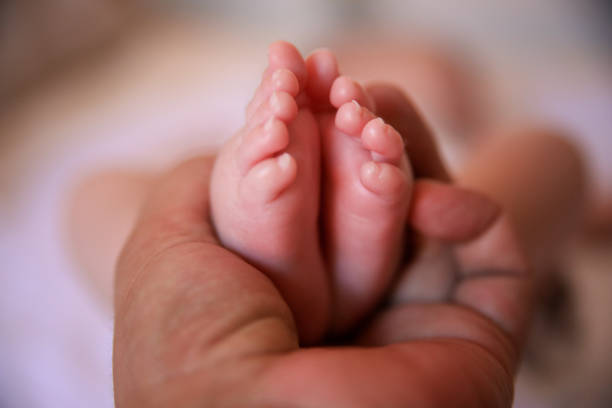 istock Father holding baby feet 1061311282