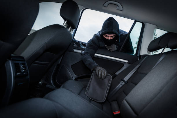 istock Thief in a mask hijacks the car 1061312982