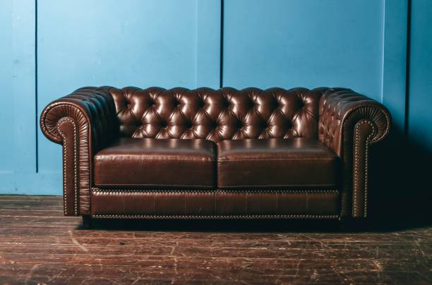 luxurious leather, brown sofa, blue wall. classic vintage furniture. - armchair sofa leather brown imagens e fotografias de stock