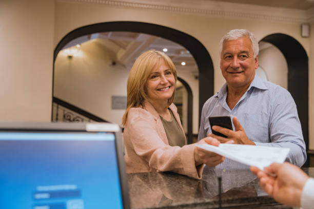 Couple Checking In at Hotel