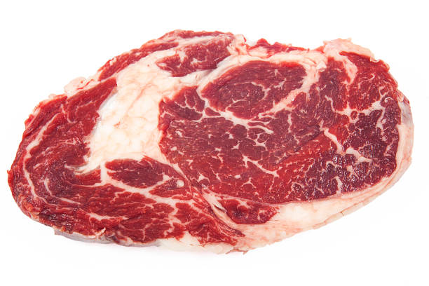 istock Fresh raw beef steak on wooden and white background. 1061319504