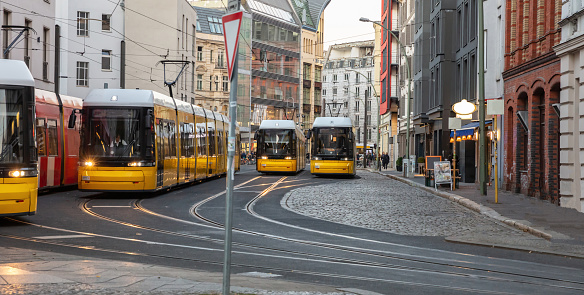 Yellow trams in the city center, office buildings background, Berlin