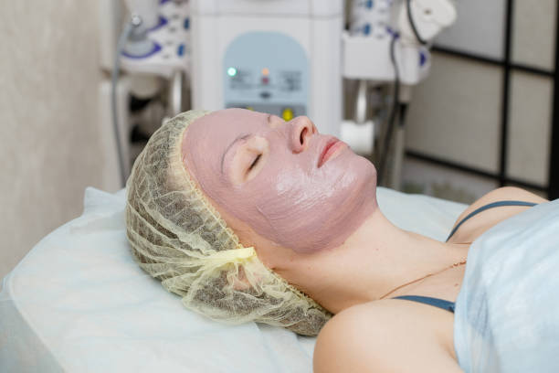 istock Woman getting face peeling mask in spa beauty salon 1061323100