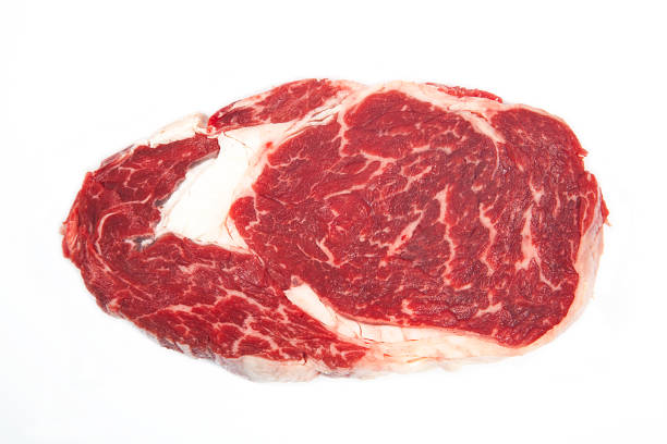 istock Fresh raw beef steak on wooden and white background. 1061328660