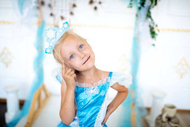 Prepare for the new year party, the snow queen or the Snow Maiden princess. Beautiful girl with a cardboard caron. Blonde holding a decoration on a wooden stick. Original accessories for photo shoots