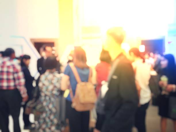 istock blurred image of people going to work on the queue line or queuing in rush hour in the morning waiting for train subway station. Stay in the crowd cause stress in everyday life. Transport concept. 1061329918