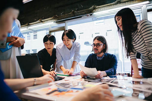 Group of people are working together in a modern working space in Tokyo.