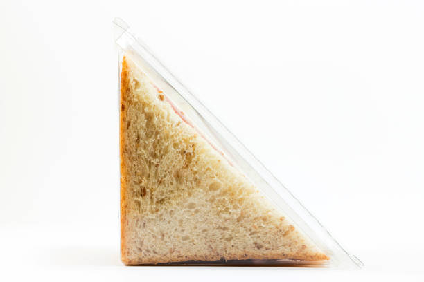 Whole wheat sandwich toast with ham and cheese in a plastic box stock photo