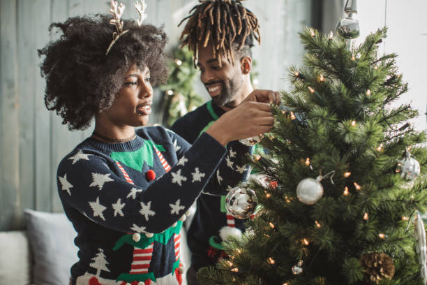 istock Couple decorate Christmas tree 1061335536