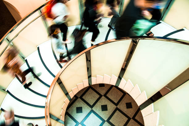 istock Motion Blur of People on Abstract Spiral Staircase 1061338538