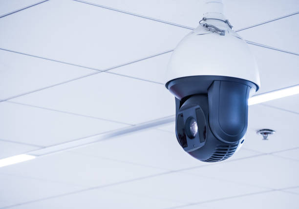 istock Cctv camera mounted on the ceiling in the office building 1061340858