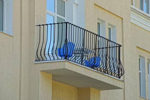 istock one open balcony with black iron rods on a brown concrete wall with windows 1061341324