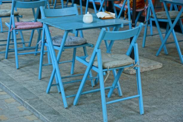 istock blue wooden table and chairs on the sidewalk 1061343014