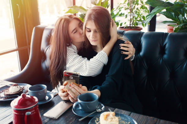 istock Two young women taking selfie with smart phone 1061357408