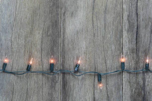 istock Christmas lights on brown wooden floor. 1061358290