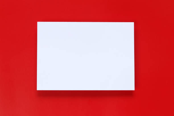 istock Blank white paper on a red art paper background. 1061358768