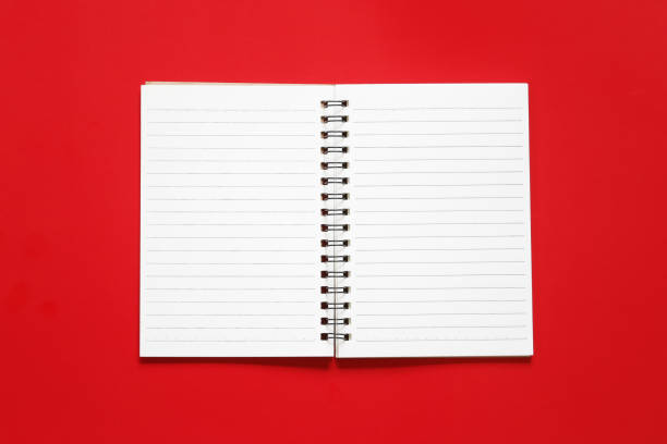istock Blank notebook paper on a red art paper background. 1061359820