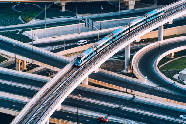 Highway intersection and Metro Train in Dubai, UAE Aerial view of a big highway intersection in Dubai, UAE rail transportation photos stock pictures, royalty-free photos & images