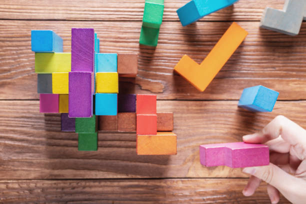 istock Concept of decision making process, logical thinking.  Hand holding wooden puzzle element. 1061368670