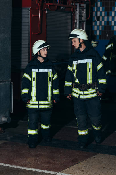 istock firefighters in protective uniform and helmets at fire department 1061369836