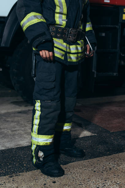 istock partial view of firefighter in protective fireproof uniform standing at fire department 1061369998