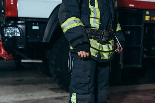 istock partial view of firefighter in protective fireproof uniform standing at fire department 1061370026