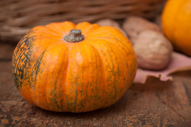 istock small pumpkins and walnuts on wooden background 1061371152