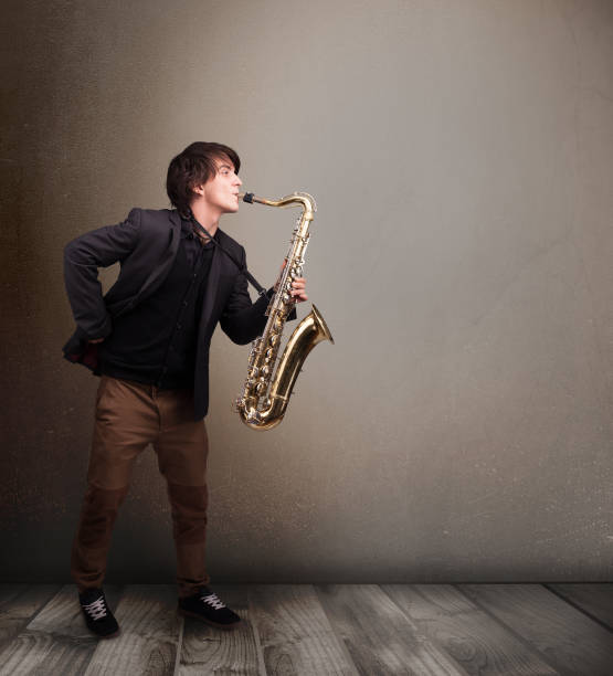 istock Young musician playing on saxophone 1061373560