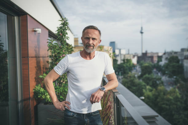 istock relaxed bearded midaged man on balcony in Berlin 1061374362