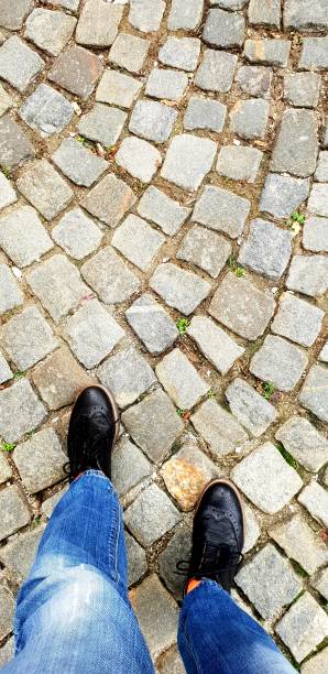 istock Cropped feet on cobble street 1061377350