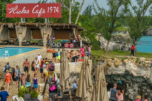 Negril, Jamaica - May 30 2015: Tourists and locals enjoy a day at the famous attraction Rick's Cafe in Negril, Jamaica