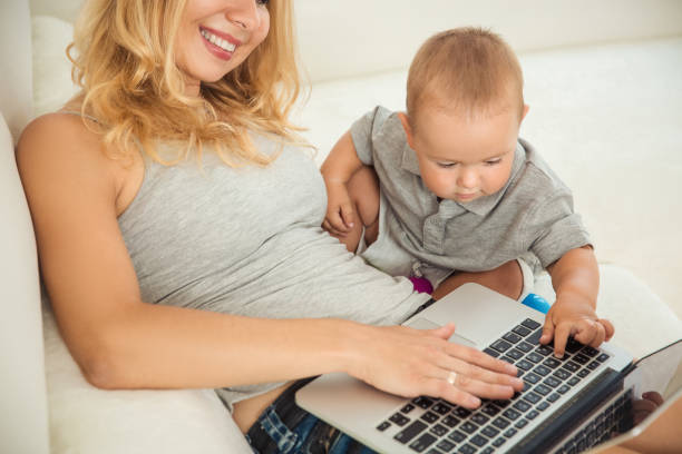 istock Happy young mother playing with her son the couch 1061387022