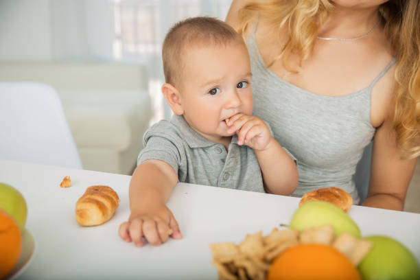 istock The child eats fruit breakfast at mom's hands 1061387026