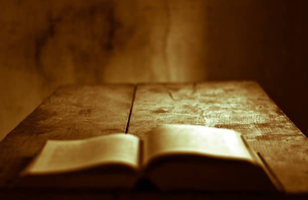 istock an old book on an ancient table in an old house 1061389470