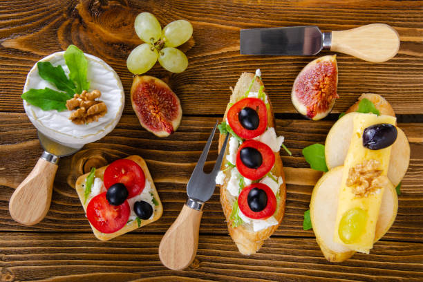 Cheese, fruit and honey. Tool for cheese. Wooden table. View from above. Cheese, fruit and honey. Tool for cheese. Wooden table. Top view. тост stock pictures, royalty-free photos & images
