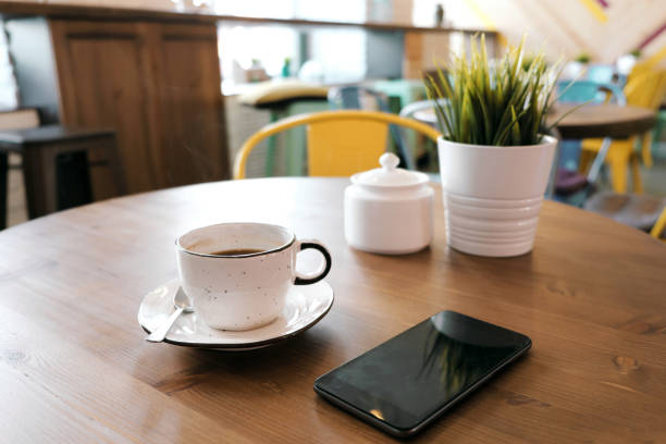 istock Coffee drink on wooden table with blur cafeteria as background. 1061390112