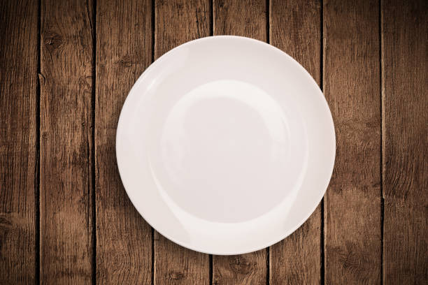 istock Colorful empty plate on grungy background table 1061390788