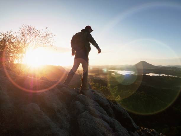 istock Climbing hiker with backpack in mountains. Rock climber 1061390872