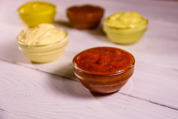 istock Different sauces in glass bowls on wooden table 1061392528