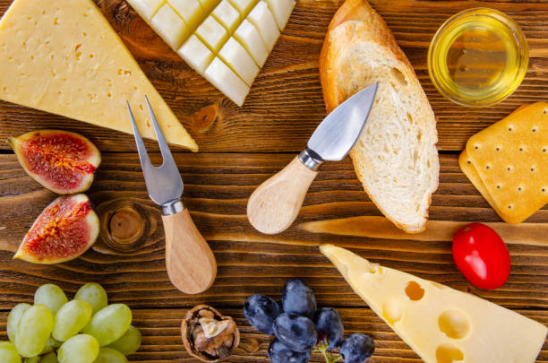 Cheese, fruit and honey. Tool for cheese. Wooden table. View from above. Cheese, fruit and honey. Tool for cheese. Wooden table. Top view. тост stock pictures, royalty-free photos & images