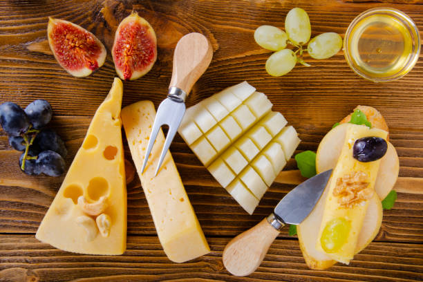 Cheese, fruit and honey. Tool for cheese. Wooden table. View from above. Cheese, fruit and honey. Tool for cheese. Wooden table. View from above. тост stock pictures, royalty-free photos & images