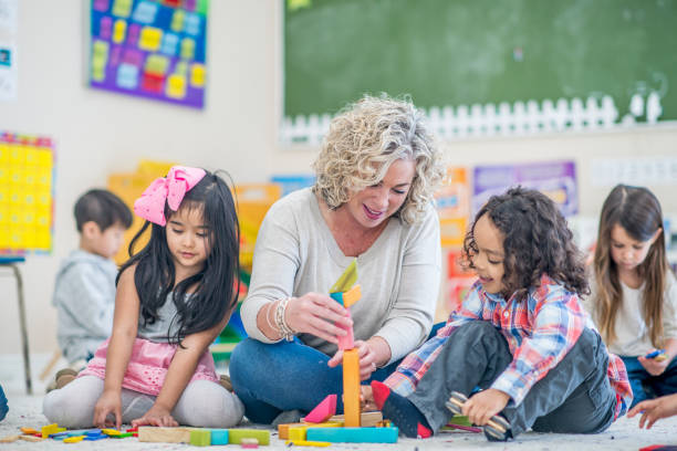 istock Kids Playing With Teacher 1061399060