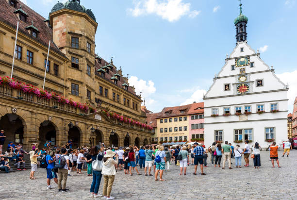 Rothenburg Ob Der Tauber, Germany - August 17, 2018: Market Place of the historic old town Rothenburg ob der Tauber with Rathaus buildings in summer. Rothenburg ob der Tauber is a famous town in Bavaria, west of Munich, Germany. This old bavarian city is situated on the Romantic Road. Rothenburg ob der Tauber is a UNESCO World Heritage site.