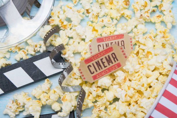 istock scattered popcorn on a blue background, a film and two tickets 1061403878