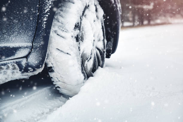 istock Car tires on winter road covered with snow 1061403962