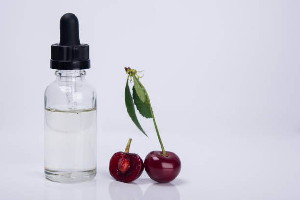istock cherry flavor in a glass container, on a white background 1061404536