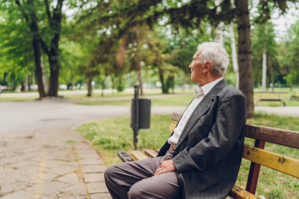 istock Senior man sitting on a park bench 1061405826