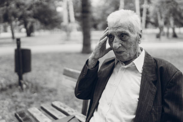 istock Sad senior man sitting on a park bench 1061406452