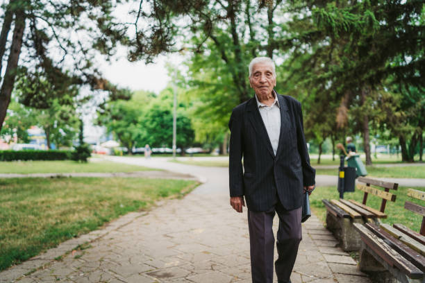 istock Senior man walking in a park 1061406706