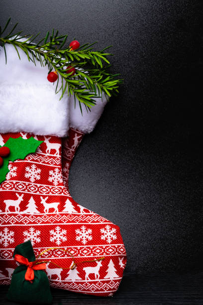 istock two Christmas stocking with deer ornament on wooden background 1061406846